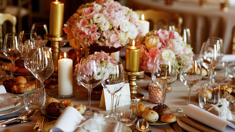 rich dinner table served pink golden tones