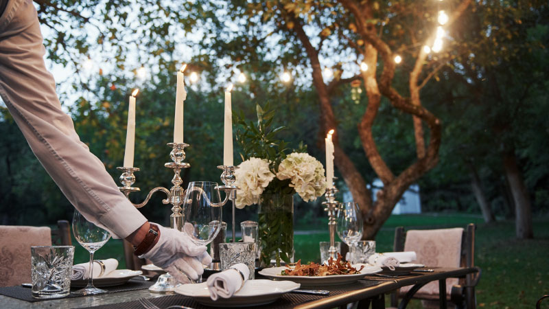 waiter hand gloves worker is engaged serving table