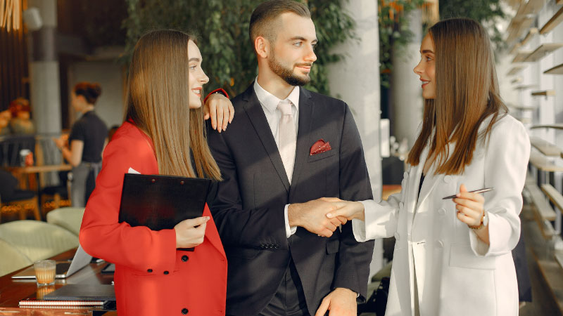 handsome businessman with women standing working cafe